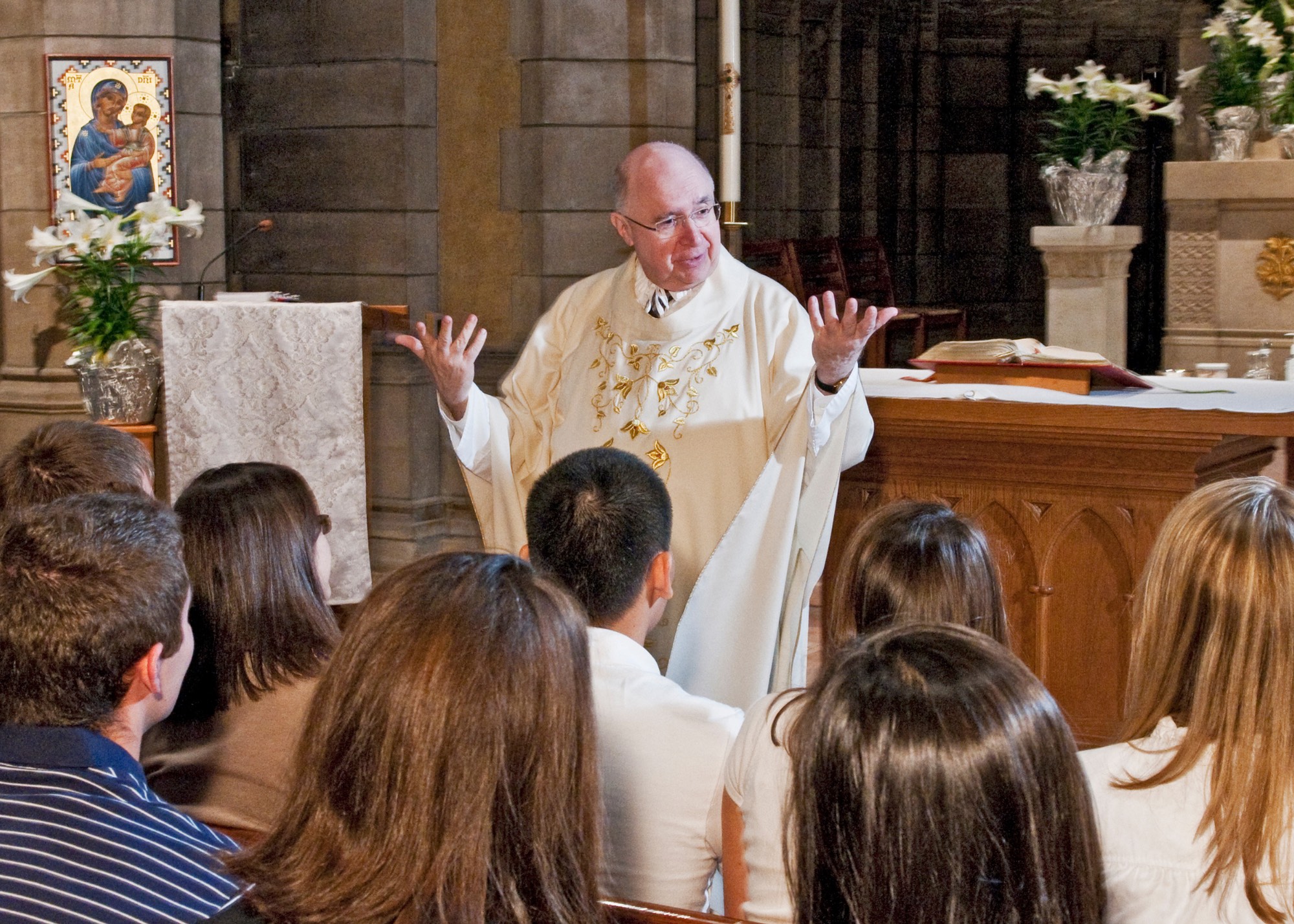 C21 Fr. Himes Guiding Light Page images - C21 Fr. Himes Guiding Light Page images smiling at Mass