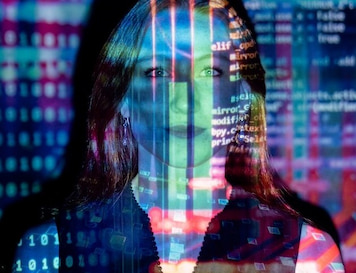 Woman Standing next to Computers