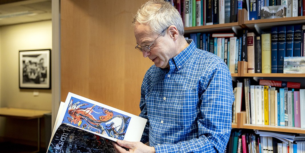 Andrzej Herczynski holding a booklet