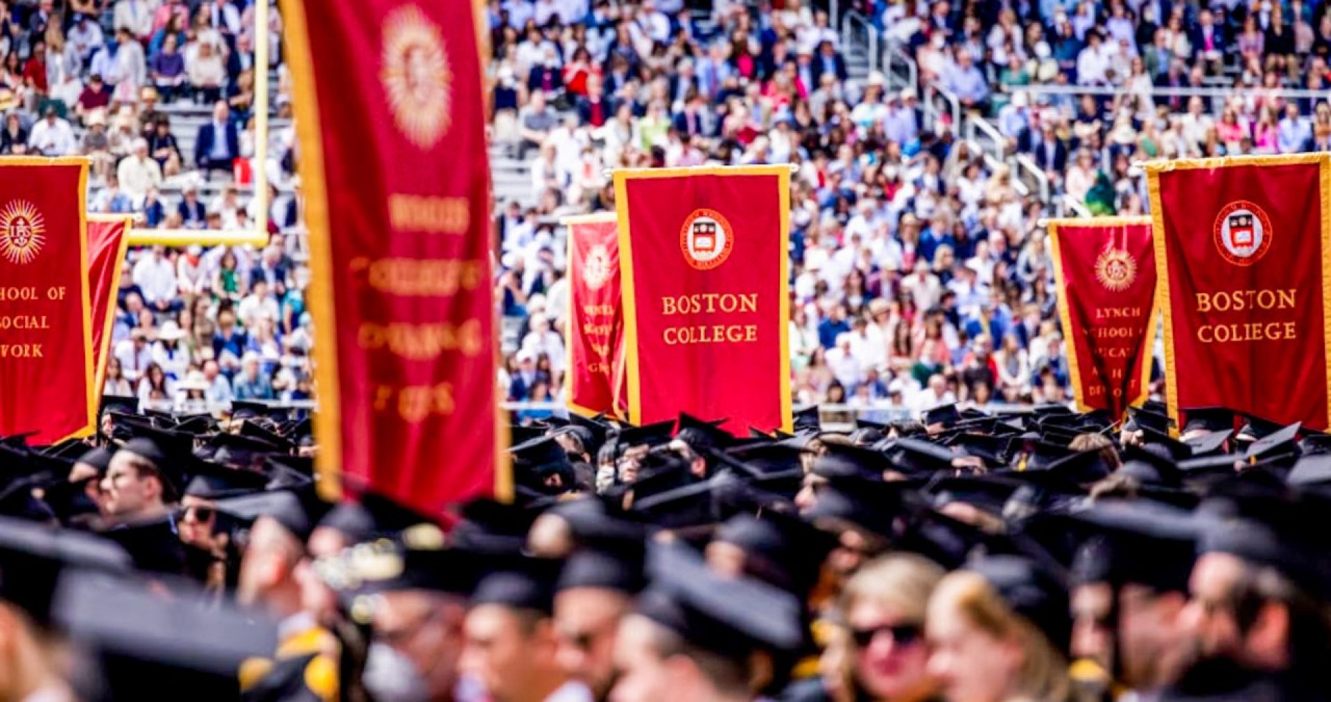 scene from Commencement with banners and graduates in cap and gown