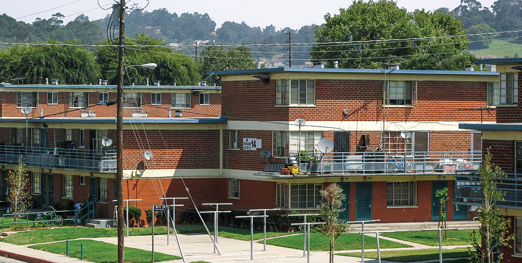 a housing development with phone wires in the foreground