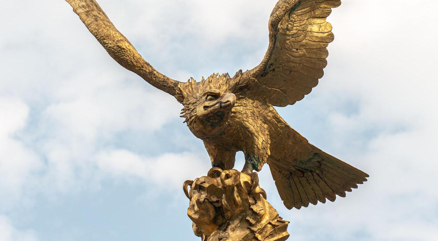 Eagle sculpture with blue sky in background