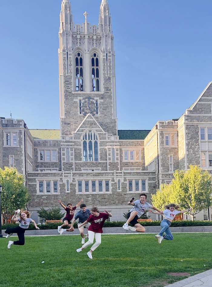 students jumping in front of Gasson Hall