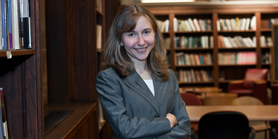 Nadya Malenko, a white woman in a blazer siting in the Fulton Honors Library