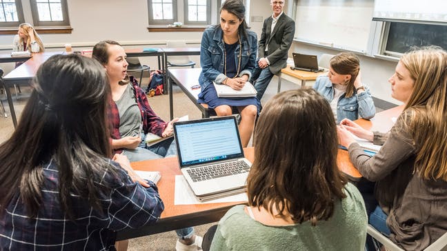 students sit in a circle and discuss