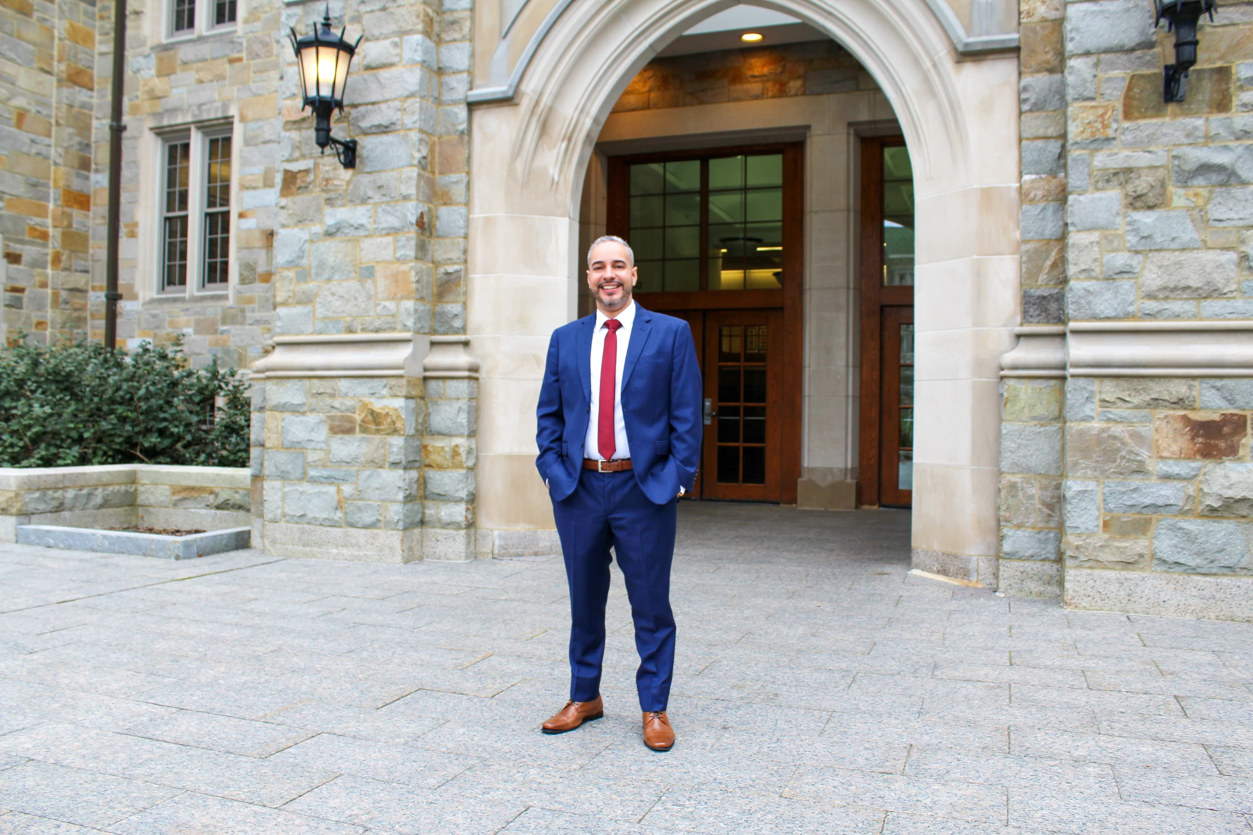 Enmanuel Cabrera in front of Fulton Hall