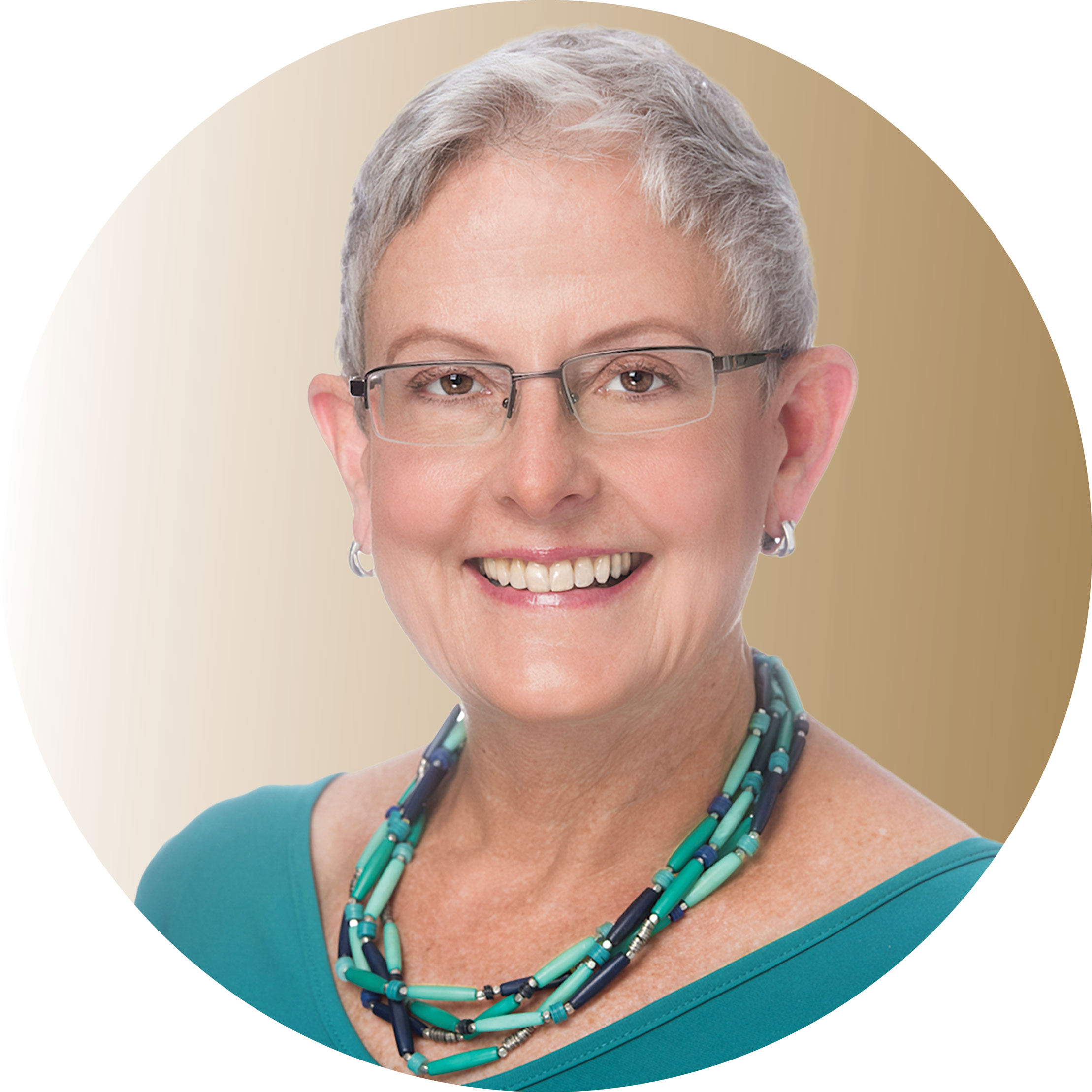 Holly Powell Kennedy in green top with multicolored necklace