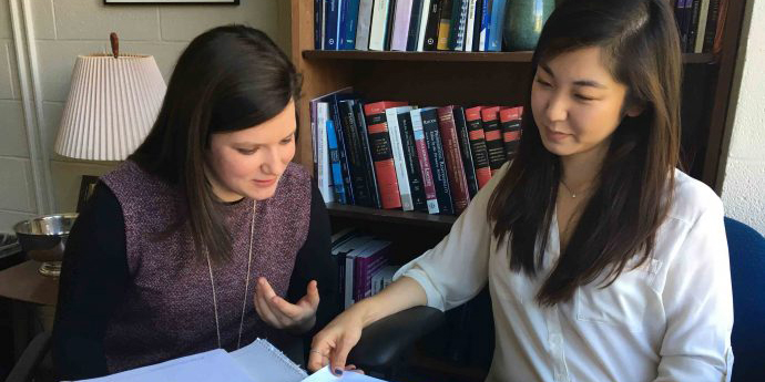 Two students working on case