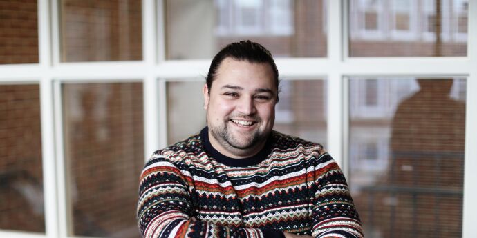 Graduate Jonathan Bertulis-Fernandes, smiling at the camera on law school campus
