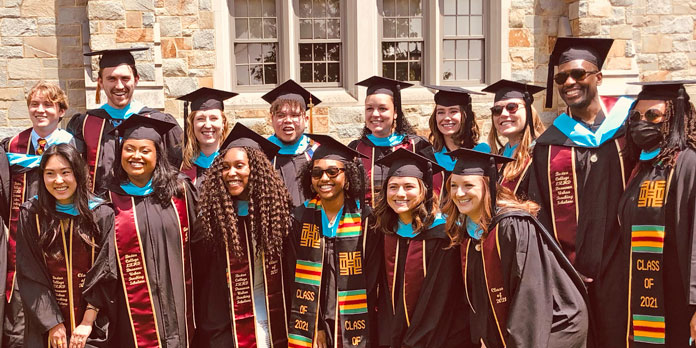 Two rows of graduating students in caps and gowns