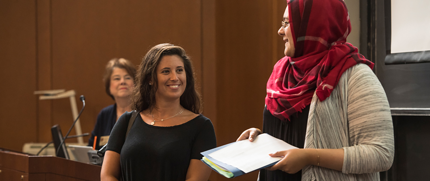 Two students speaking at an event