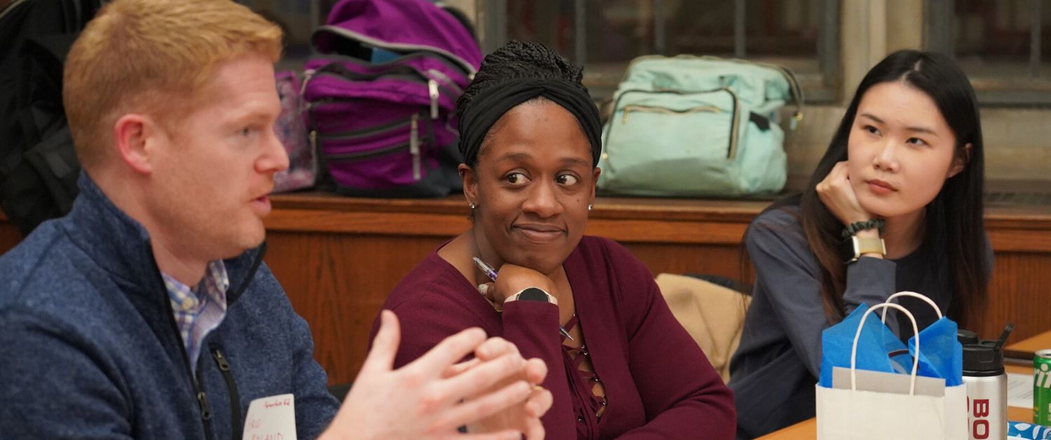 grad students talking at a table