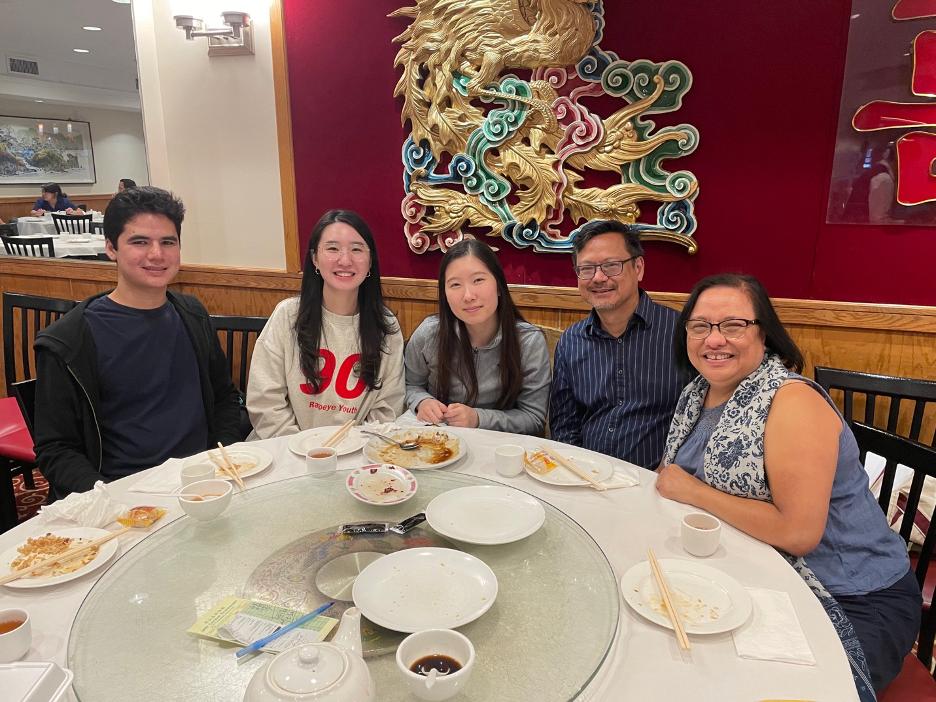 A group of students at a restaurant with their professor