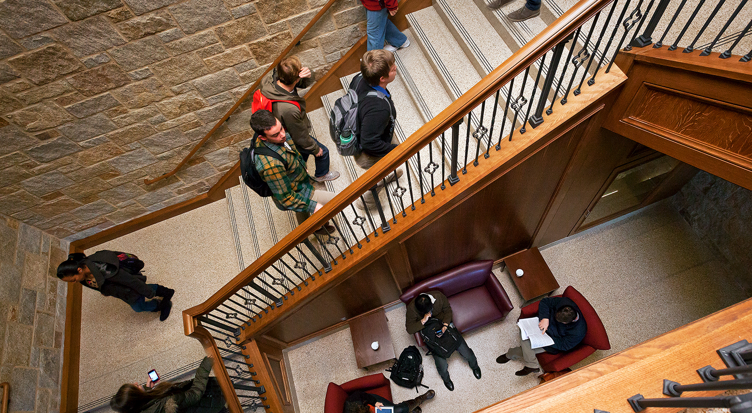 Students ascending the interior stairway in Stokes Hall