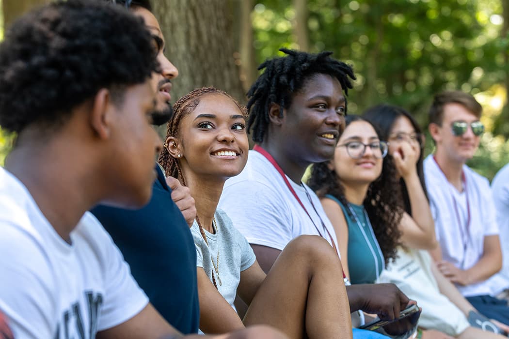 Several Messina College students sitting in a group during their orientation.