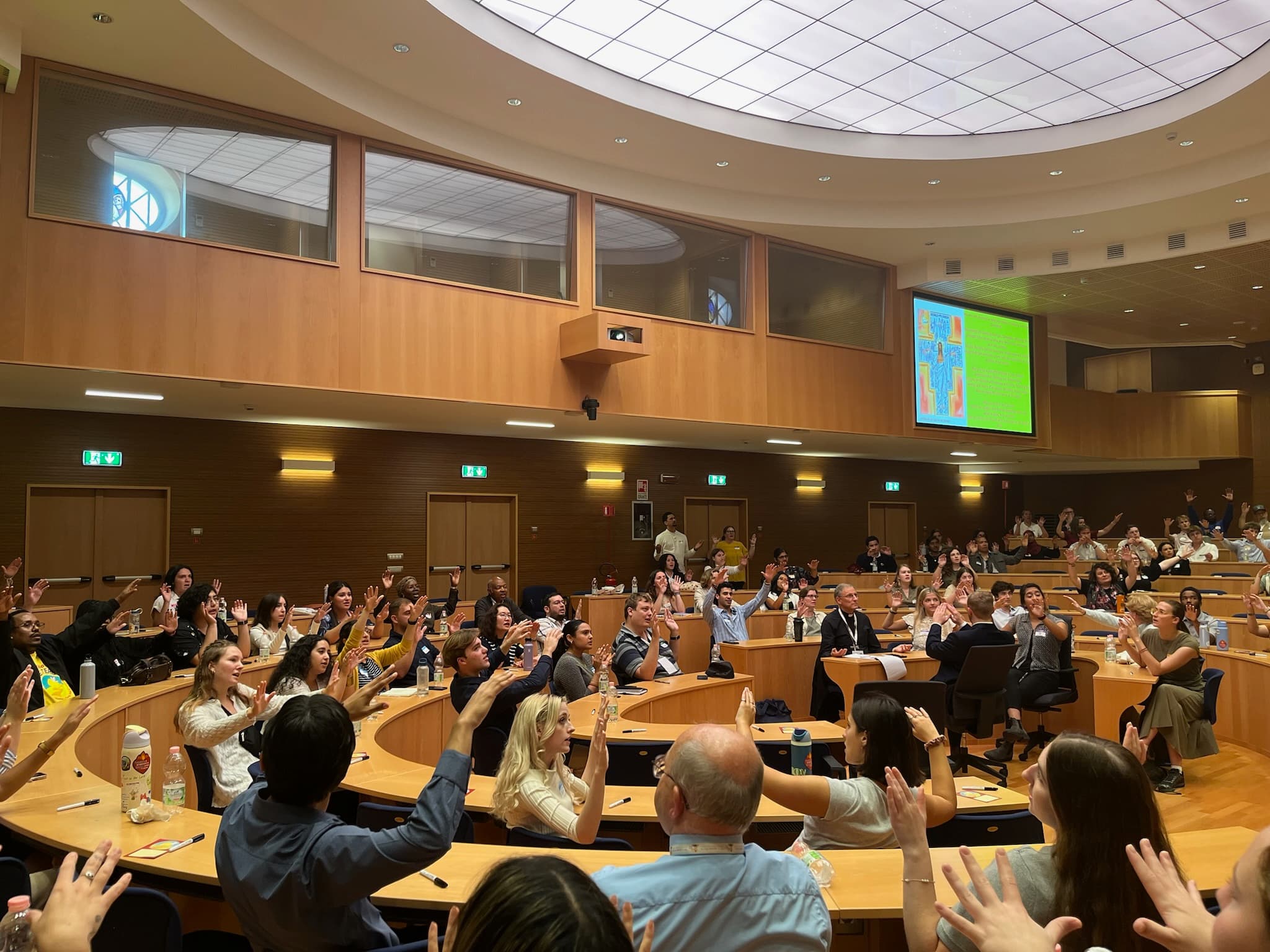 Students and synod delegates blessing one another