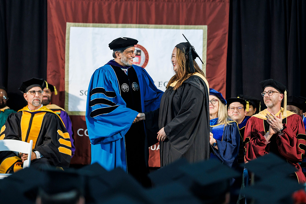 Dean Gautam N. Yadama congratulates a graduate.