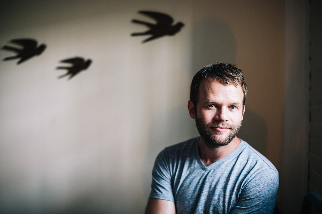 A portrait of Timothy Williams in a blue T-shirt.