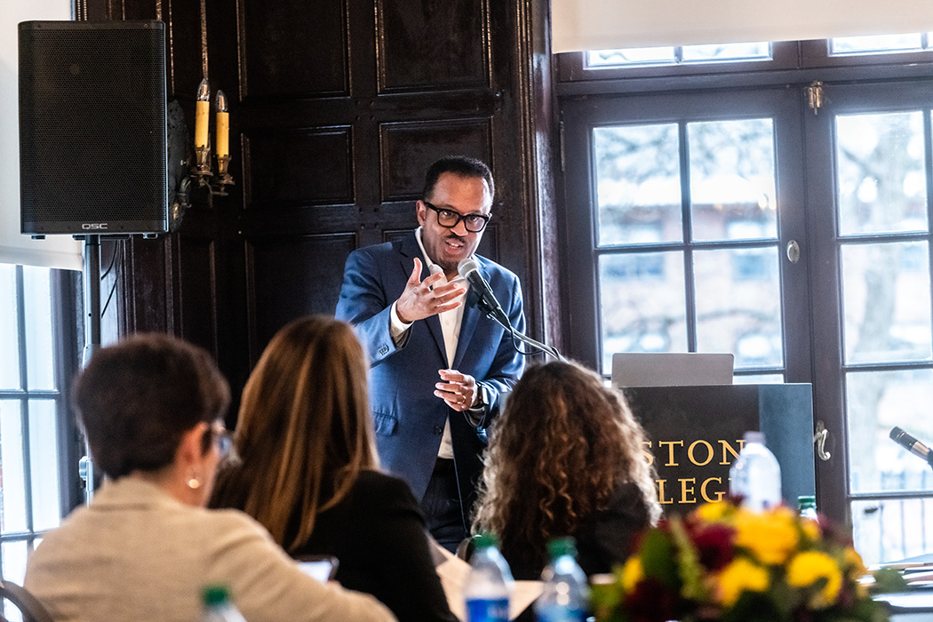 Dexter R. Voisin moderates a series of presentations in front of a podium.
