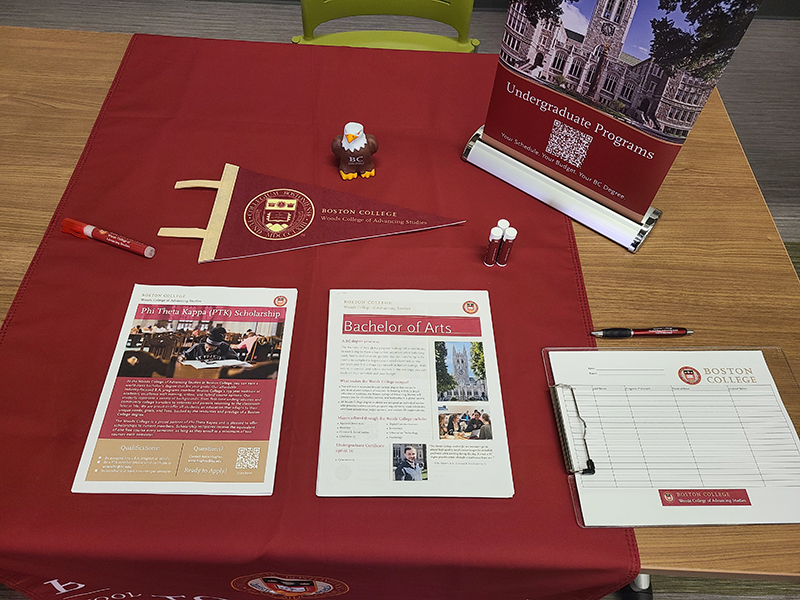 Woods College table with giveaways and documents about the program