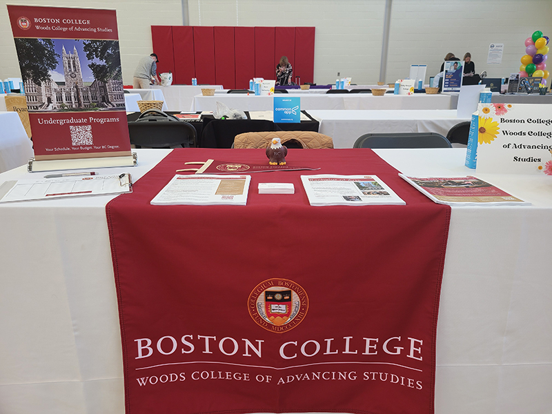 Woods College table with giveaways and documents about the program