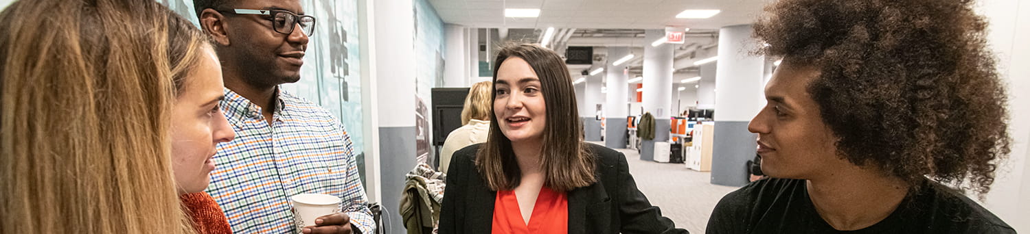 students talking in a hallway