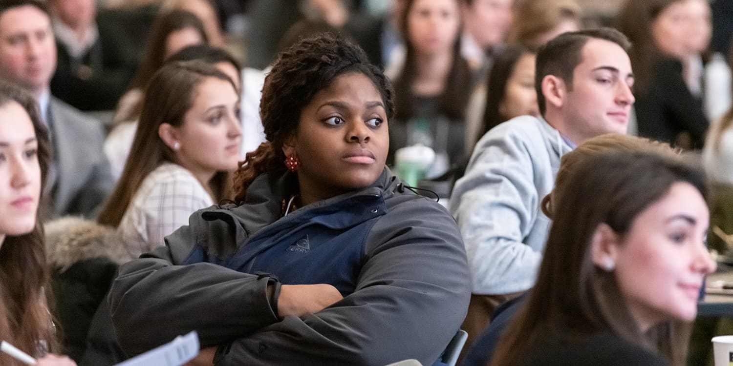 woods students at tables during a research conference