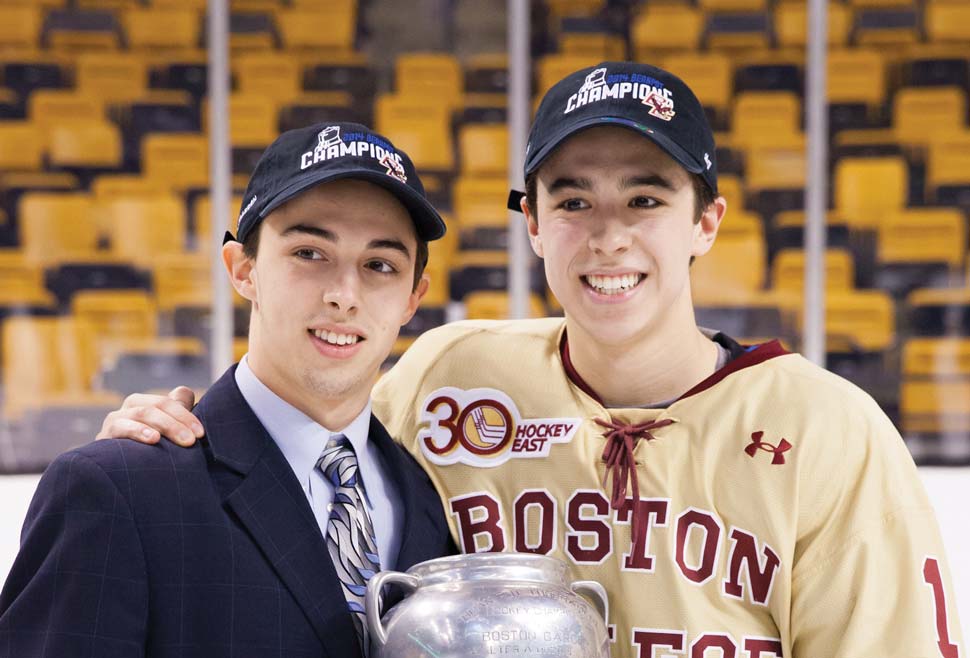 Brothers Johnny Gaudreau and Matthew Gaudreau arm in arm holding the Beanpot trophy