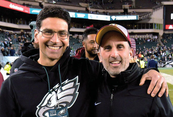 Matt Pepe and Chris Annunziata on the sidelines of a football field