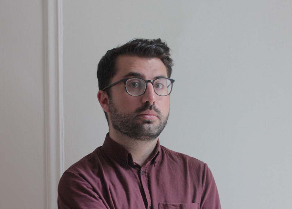 Lawson photographed with a gray wall in the background