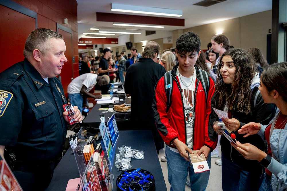 A police officer speaking with students