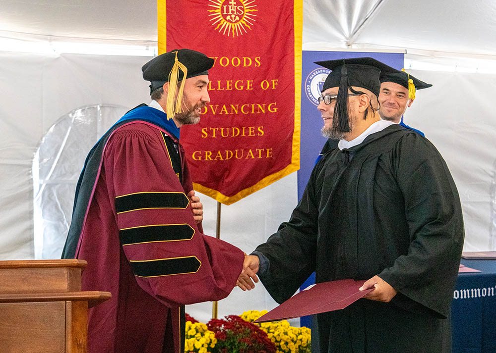 PEP Ignacio Chair Patrick Conway congratulates graduate Alex Delgado.