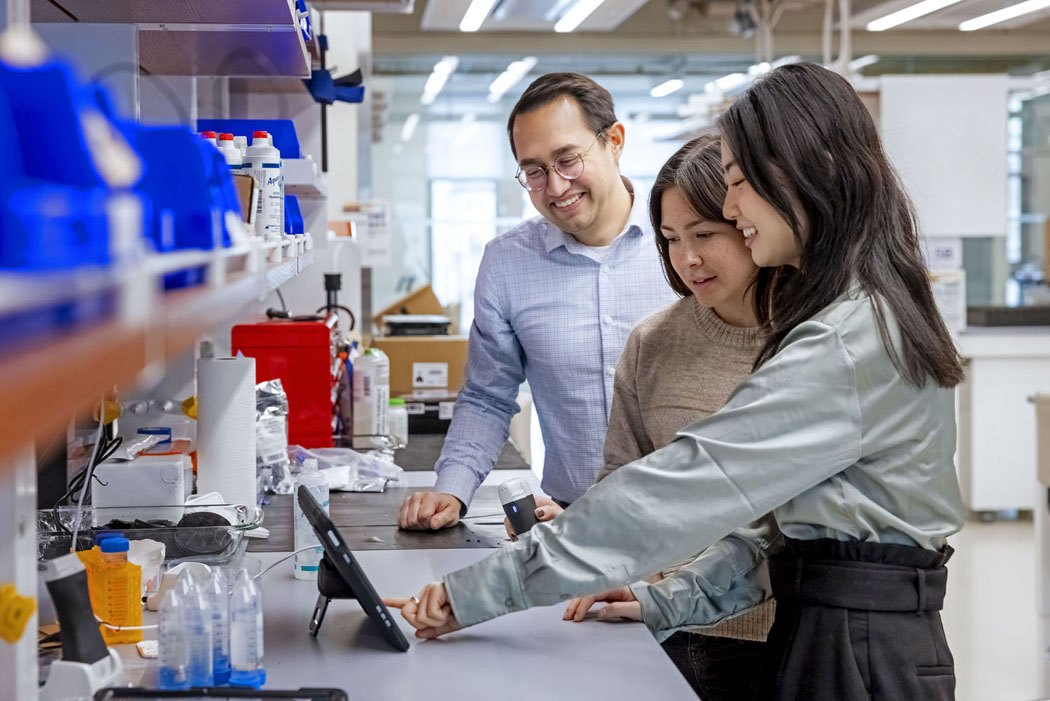 Bryan Ranger and two students in a lab