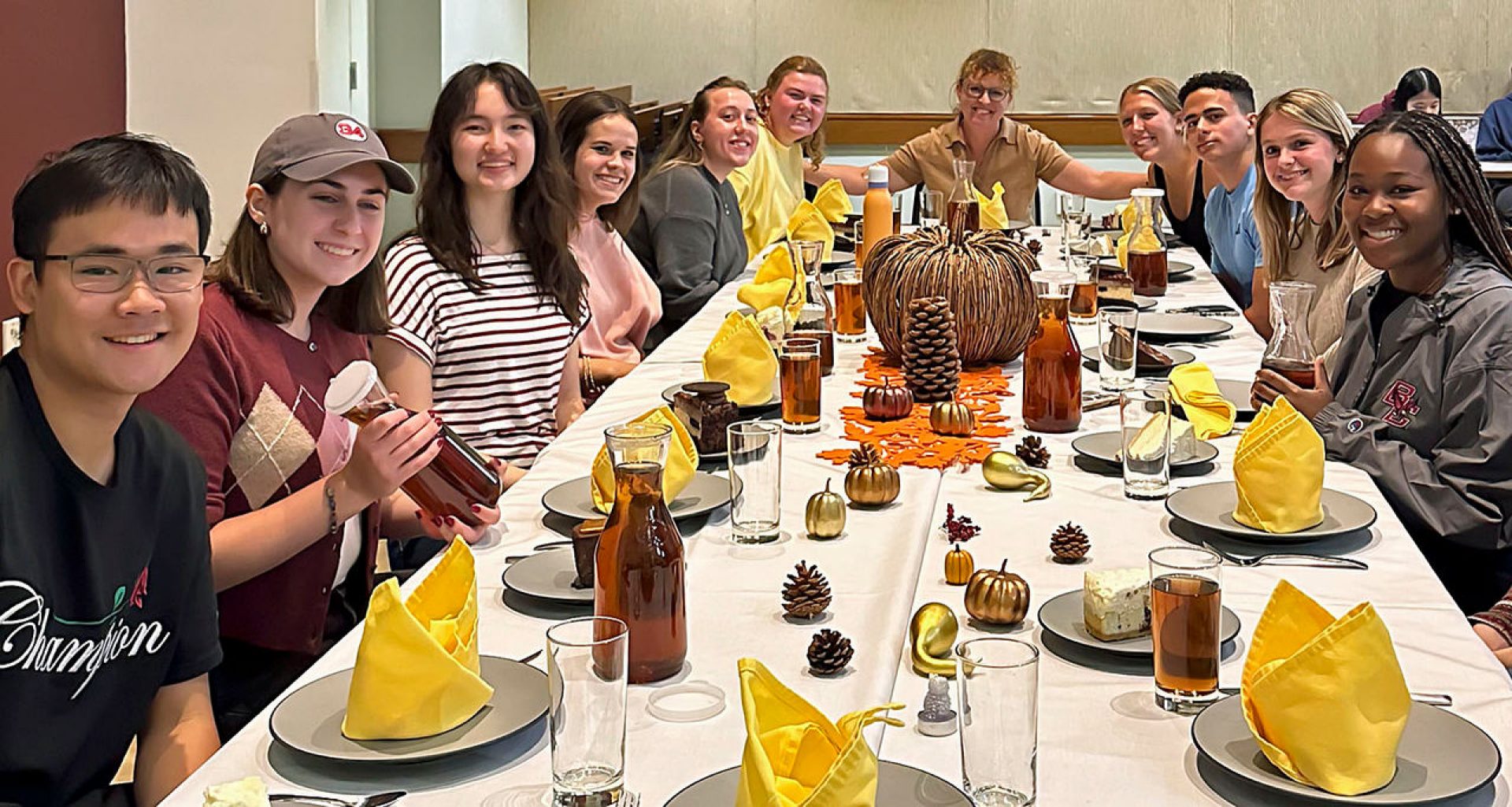 students and a faculty member at a dining table
