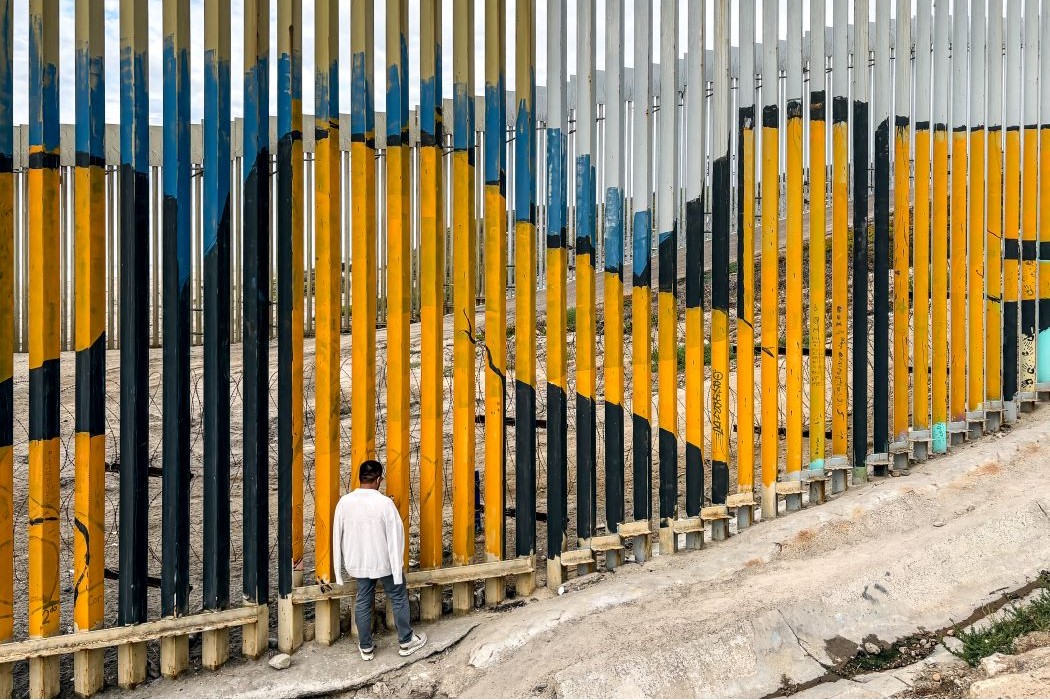 Colloquium attendees gathered at the border wall in Tijuana, Mexico. 