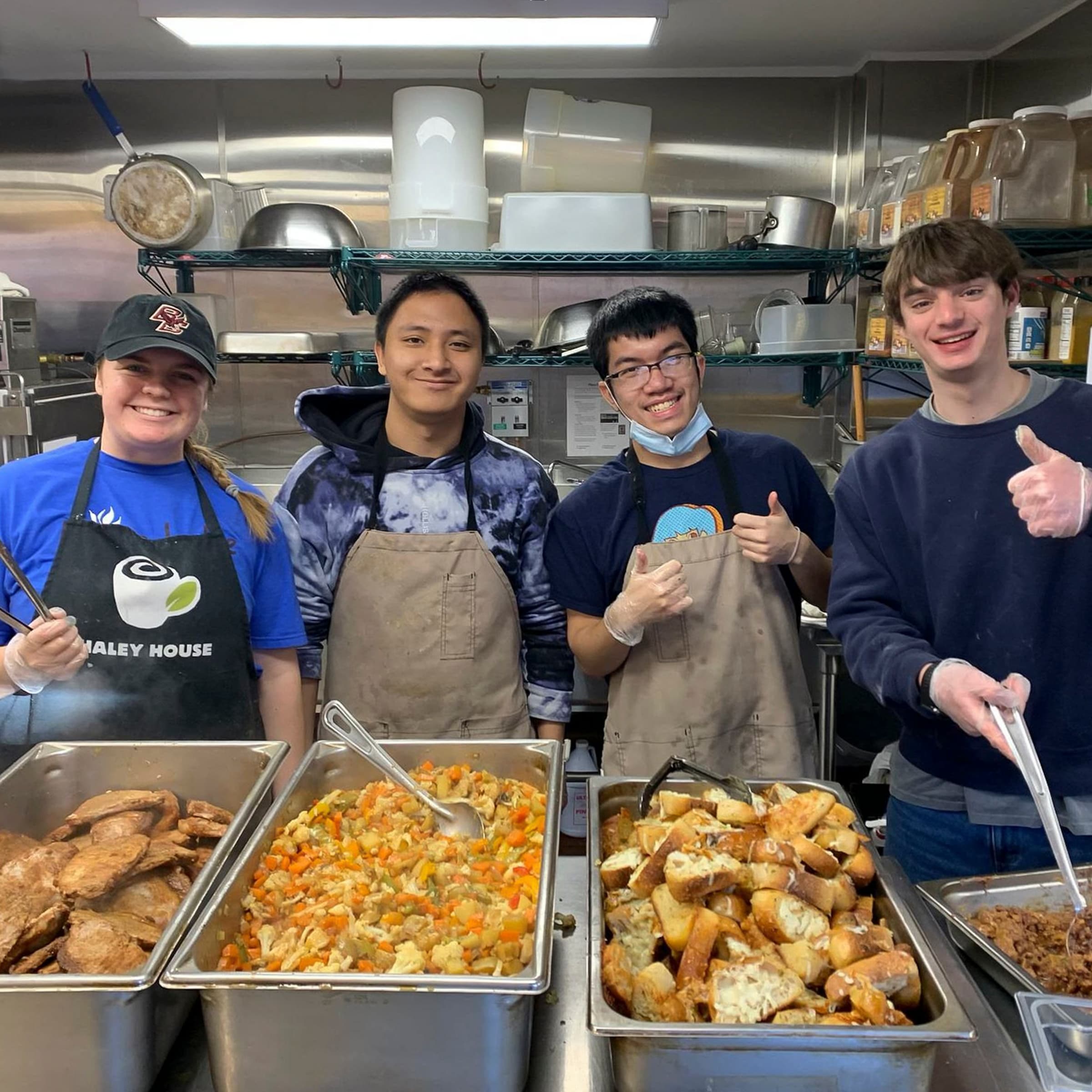 four students at the soup kitchen