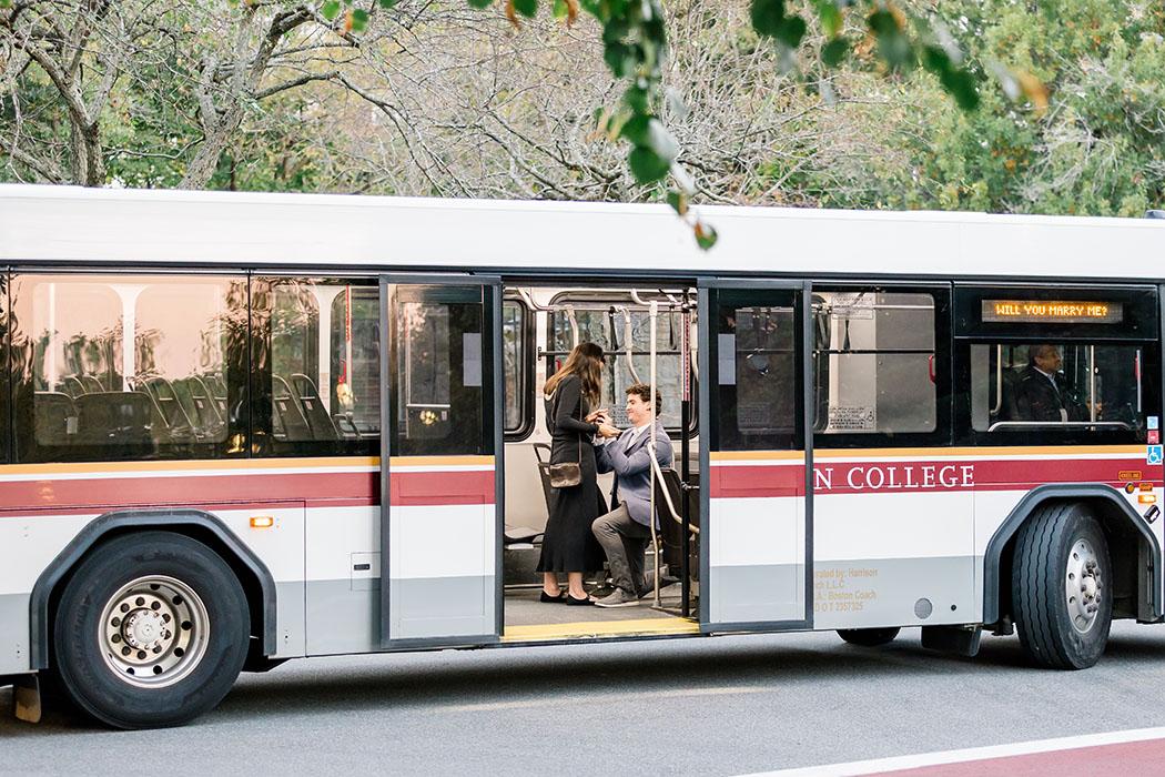 Two people aboard a shuttle bus