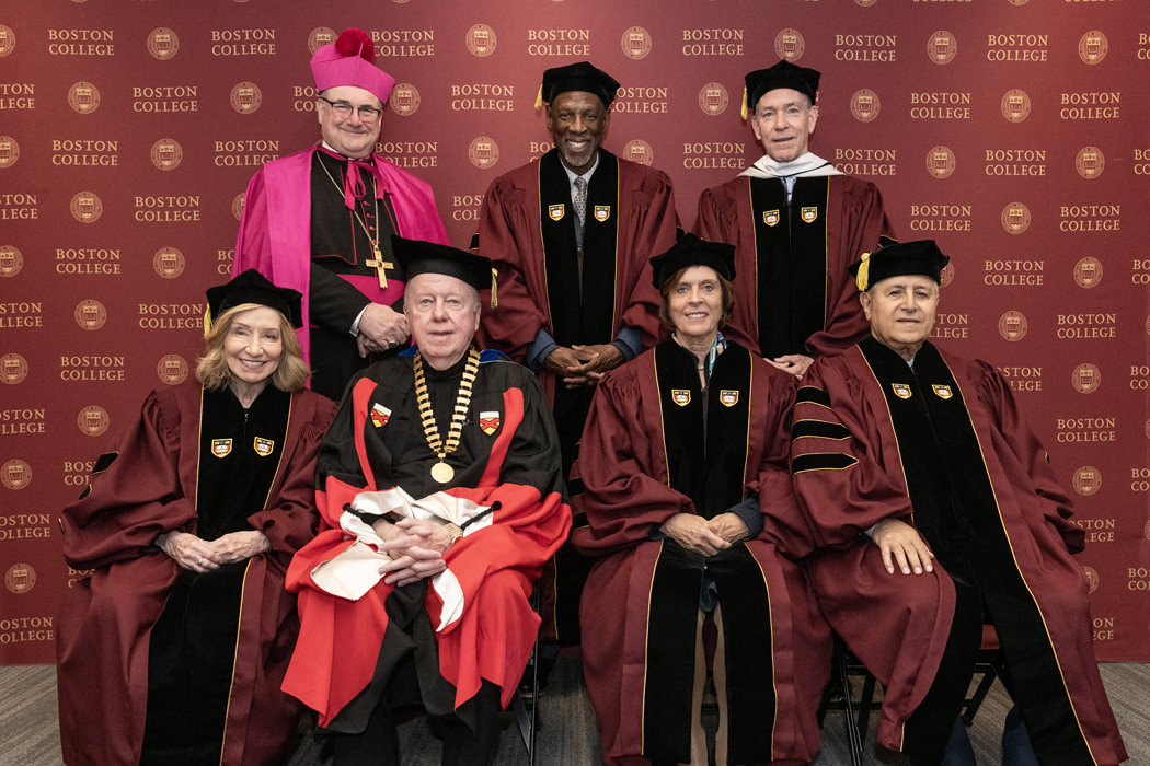 Robing room candids, group photos and photos with Fr. Leahy in the men's hockey locker room in Yawkey.
L-R: seated Doris Kearns Goodwin, William P. Leahy S.J., Dame Louise Richardson, Salim Daccache, S.J. Standing, Archbishop Richard G Henning, Geoffrey Canada, and John Fish
