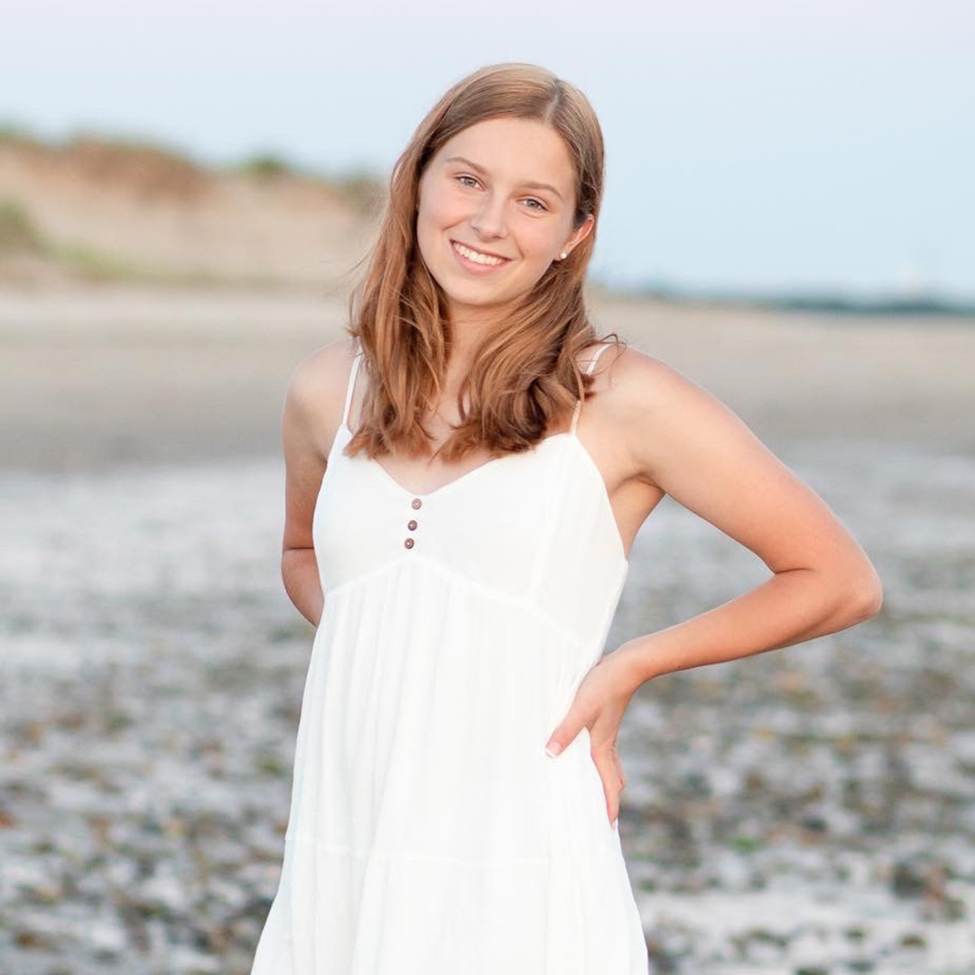 A woman posing on a beach