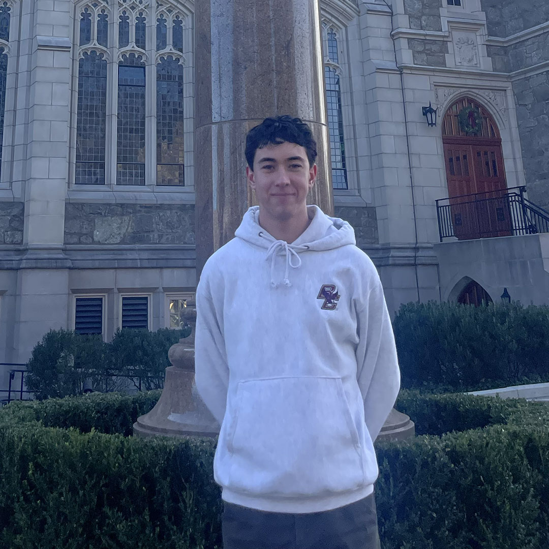 A man standing in front of Gasson Hall