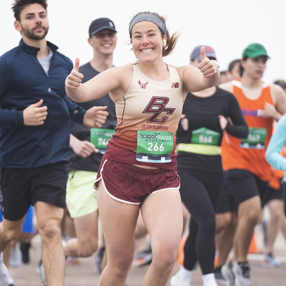 A woman running with a BC singlet