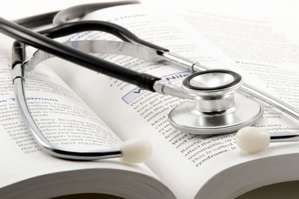 stethoscope resting on an open book
