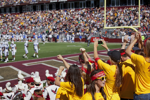 BC students cheering at a football game in Alumni stadium