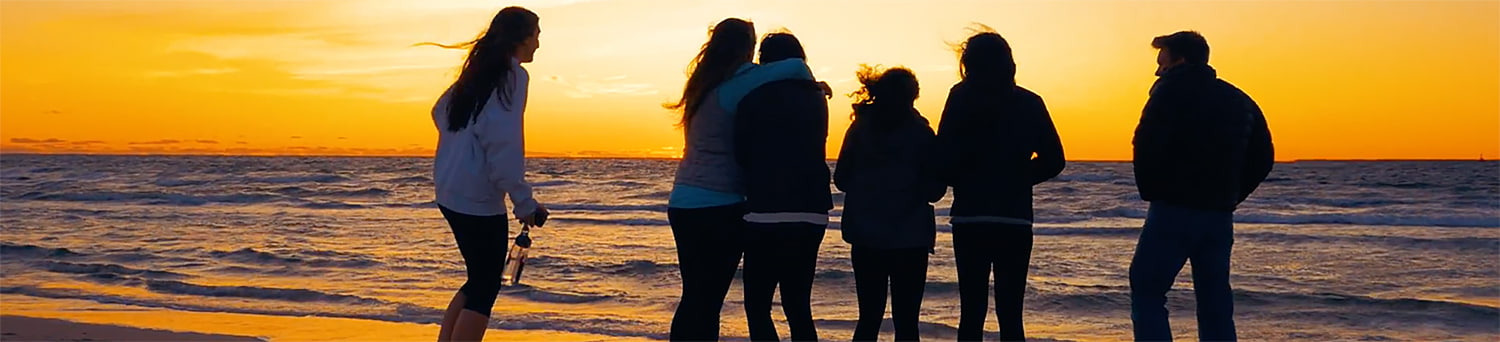 Students at beach at sunset