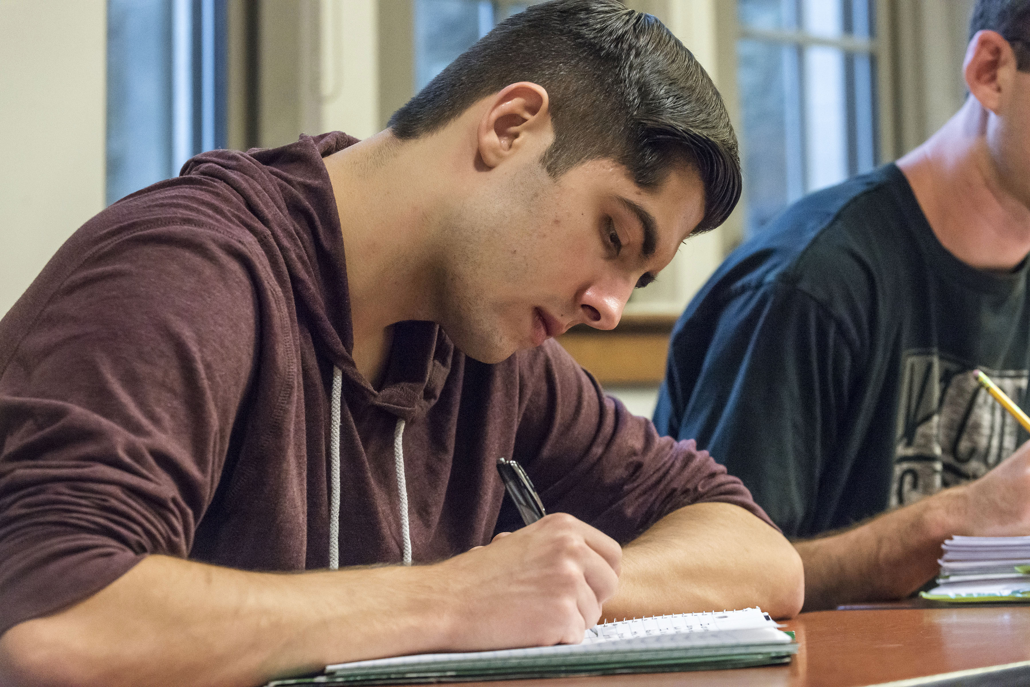 a student writing in a journal