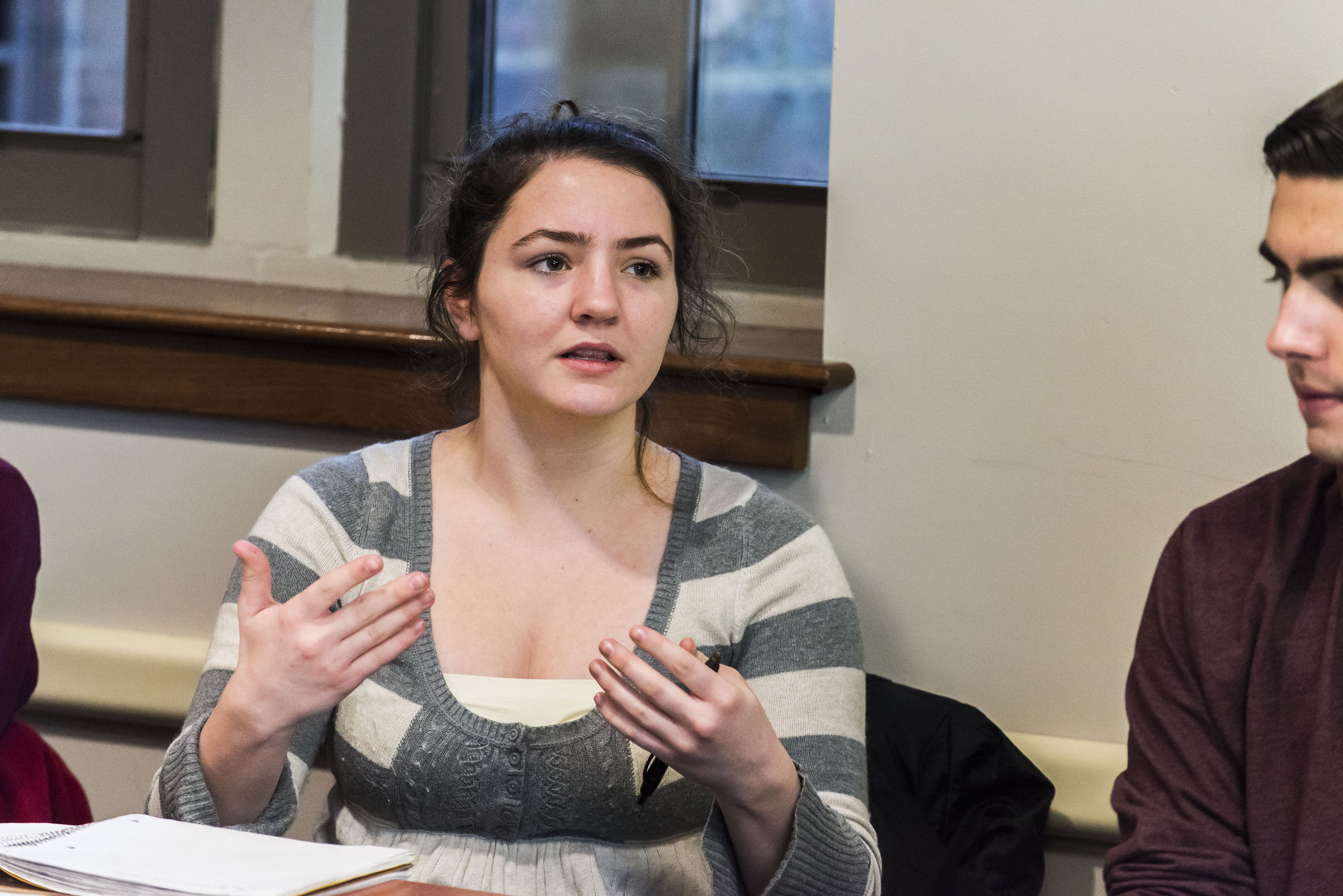 students speaking animatedly in class